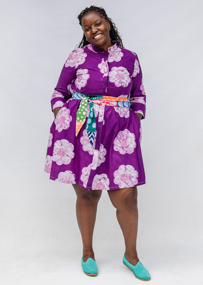 Model wearing purple and white floral print dress.
