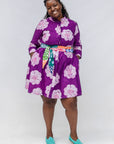 Model wearing purple and white floral print dress.