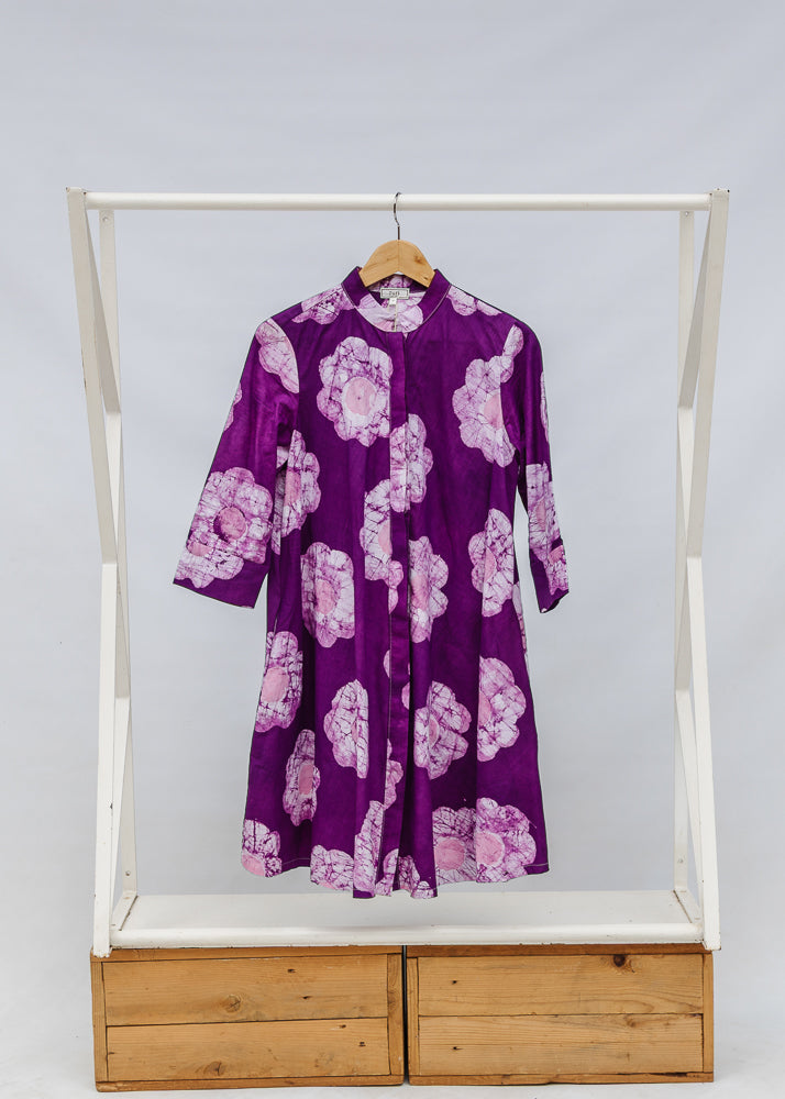 Display of purple and white floral print dress.