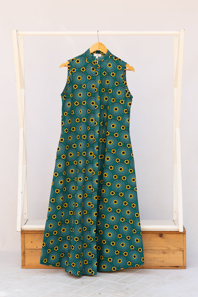 Display of teal dress with yellow sunflower print.