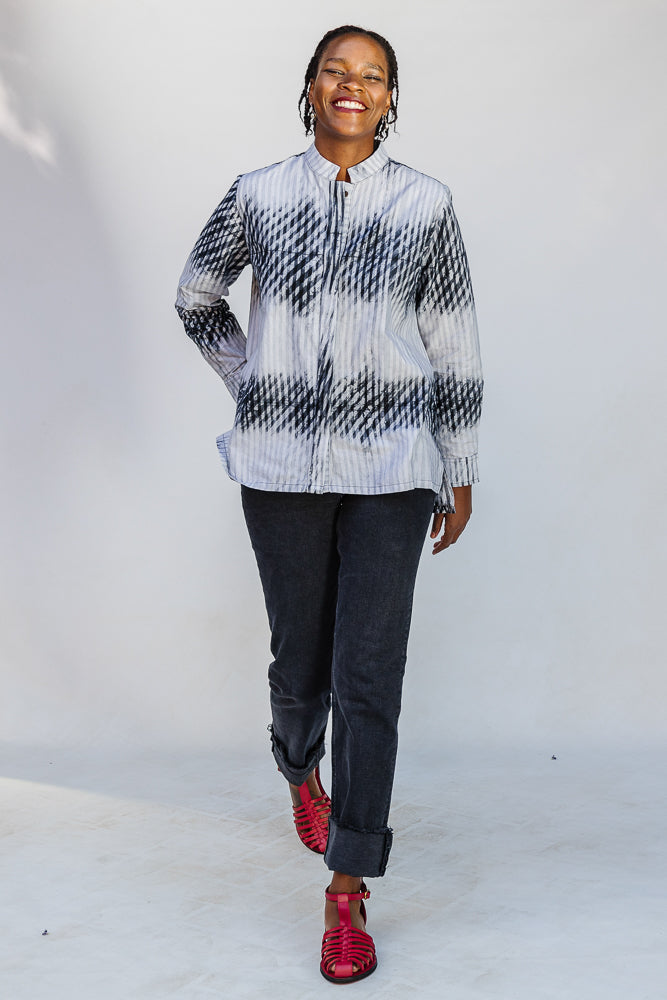 Model wearing white and black batik shirt.