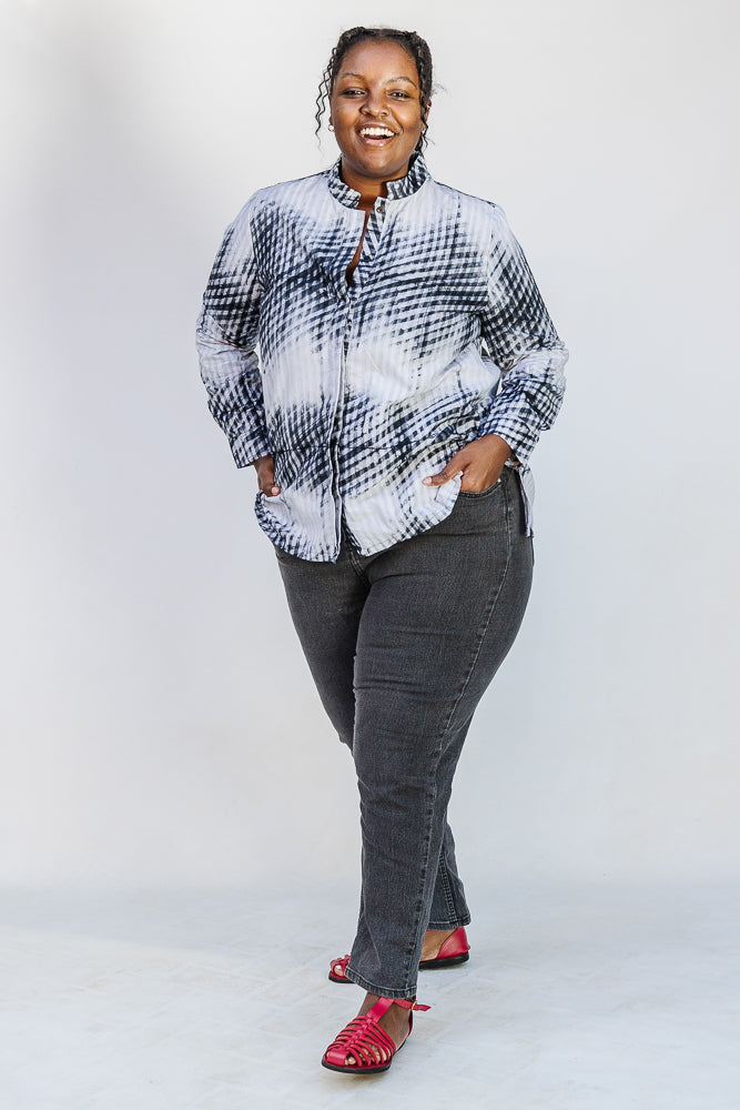 Model wearing white and black batik shirt.