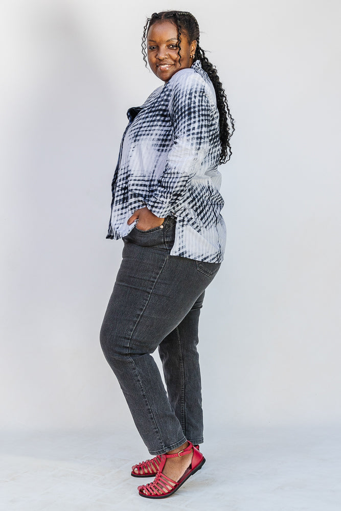 Model wearing white and black batik shirt.