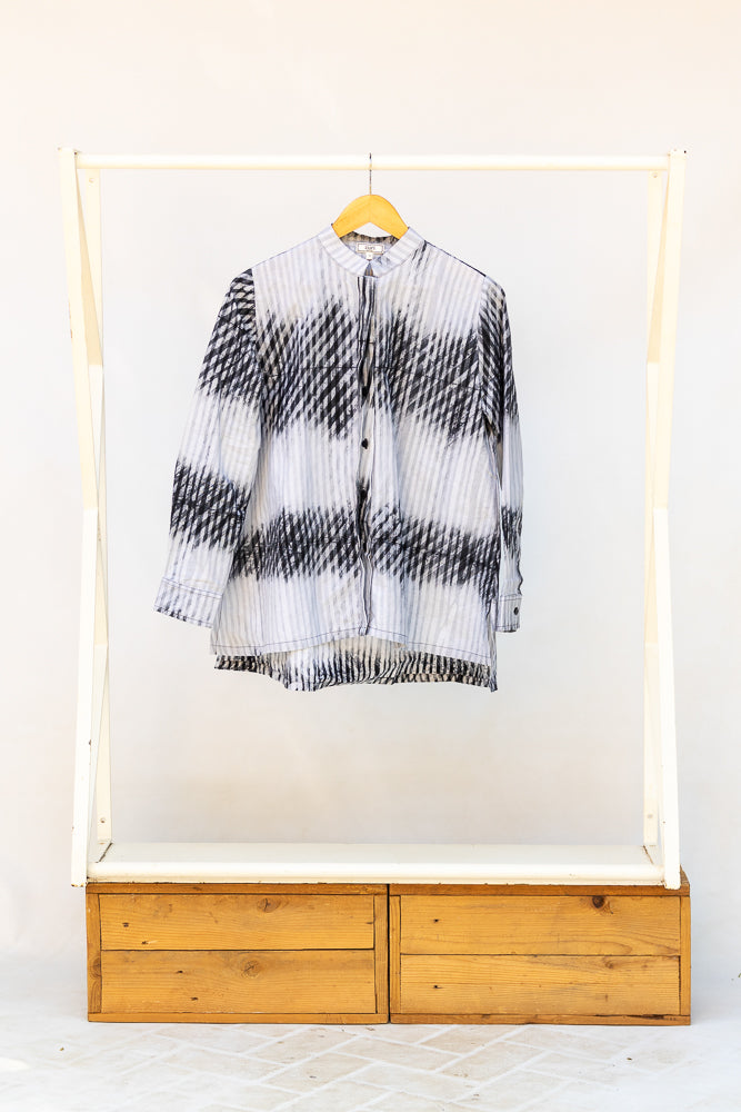 Display of white and black batik shirt.