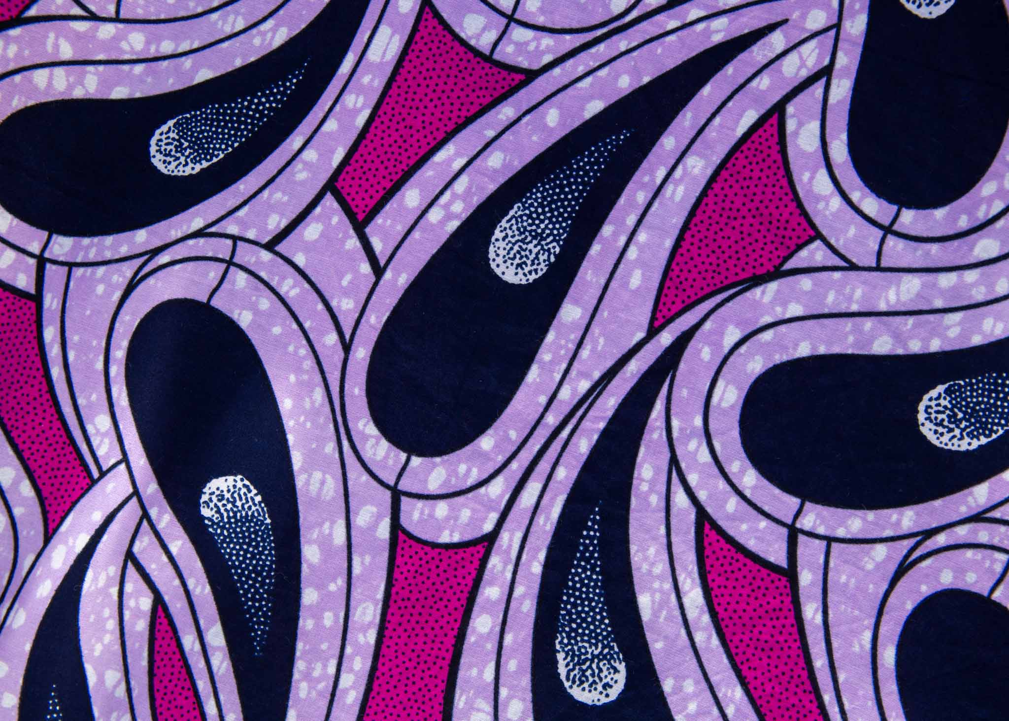 Close up display of purple and pink geometric print dress, fabric.
