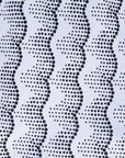 Close up display of black and white sleeveless dress, fabric.