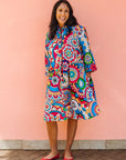 Model wearing rainbow mosaic print dress.