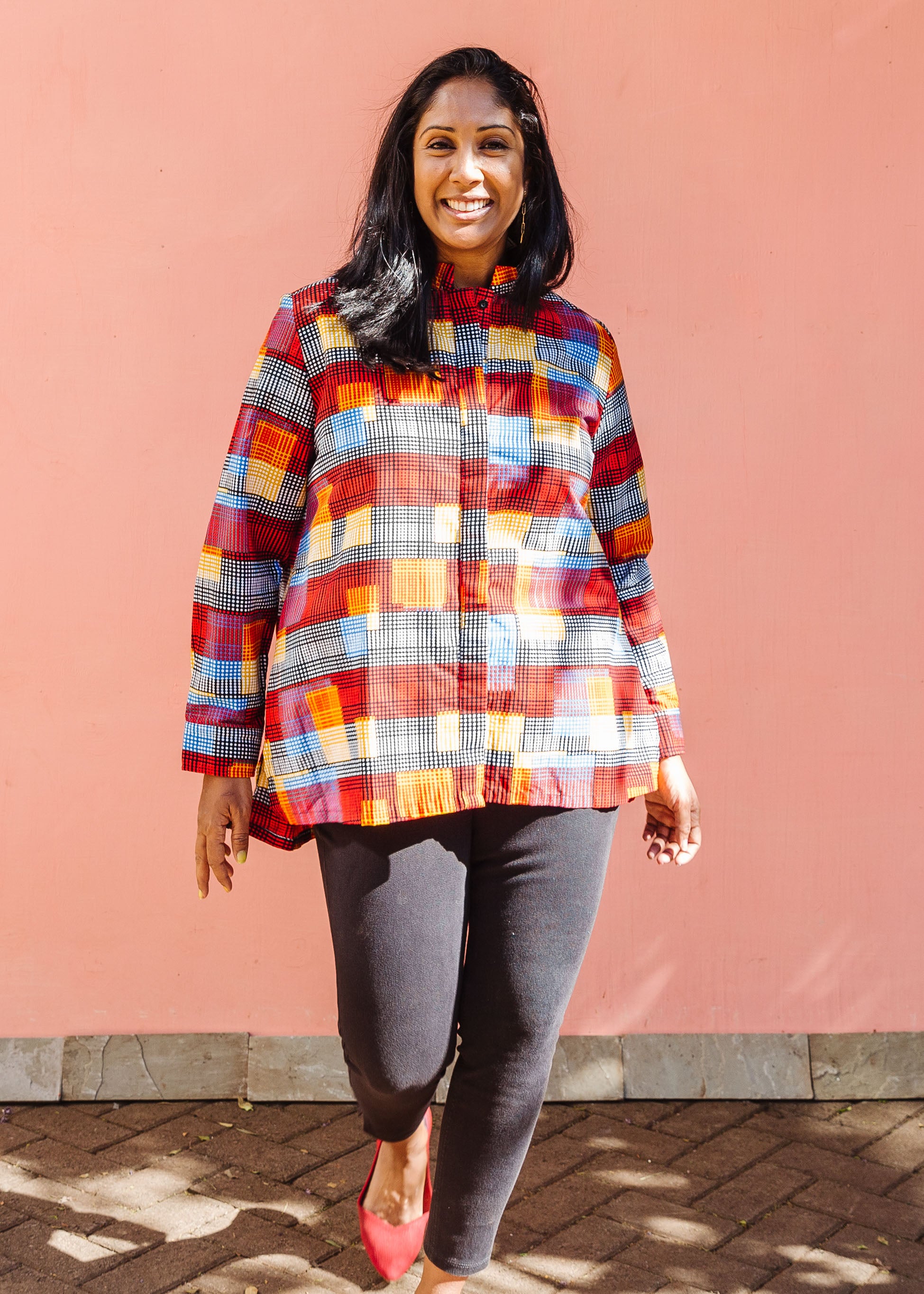 Model wearing rainbow dot print long sleeve shirt. 