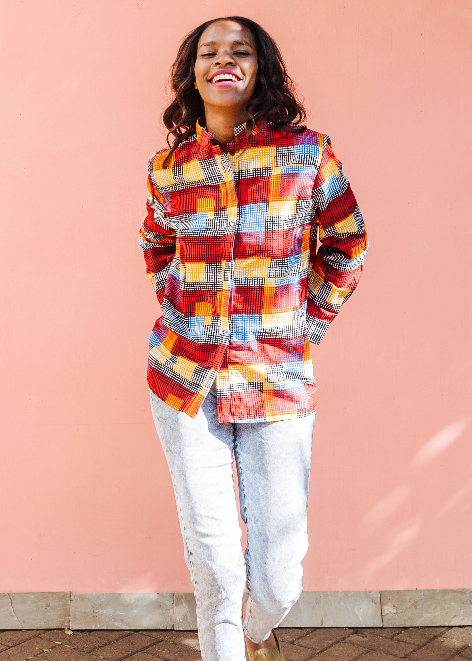 Model wearing rainbow dot print long sleeve shirt. 