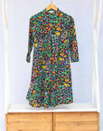 Display of navy blue dress with rainbow color umbrella shaped print 