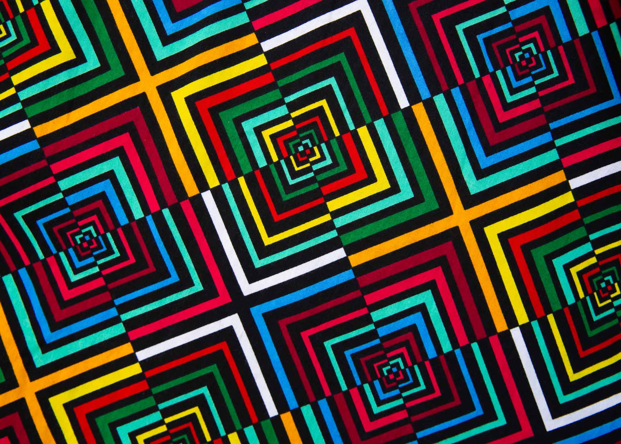 Close up display of geometric print with rainbow colored dress 