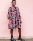 The model is wearing  Burgundy, white and navy blue floral print dress
