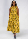 Model wearing yellow dress with black and white paisley print.