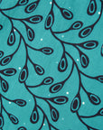 Close up display of teal leaf print dress