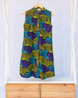 Display of black dress with purple , yellow and turquoise dotted fans