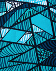 Close up display of turquoise geometric print dress / fabric 