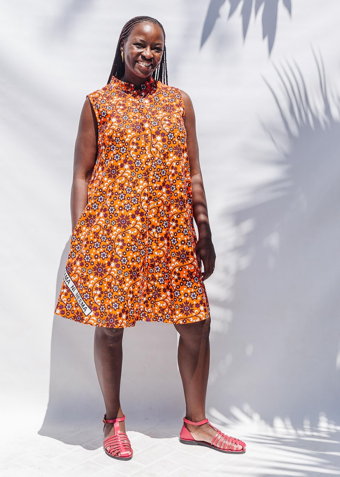 The model is wearing multi-colored floral print dress