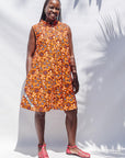 The model is wearing multi-colored floral print dress