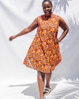 The model is wearing multi-colored floral print dress