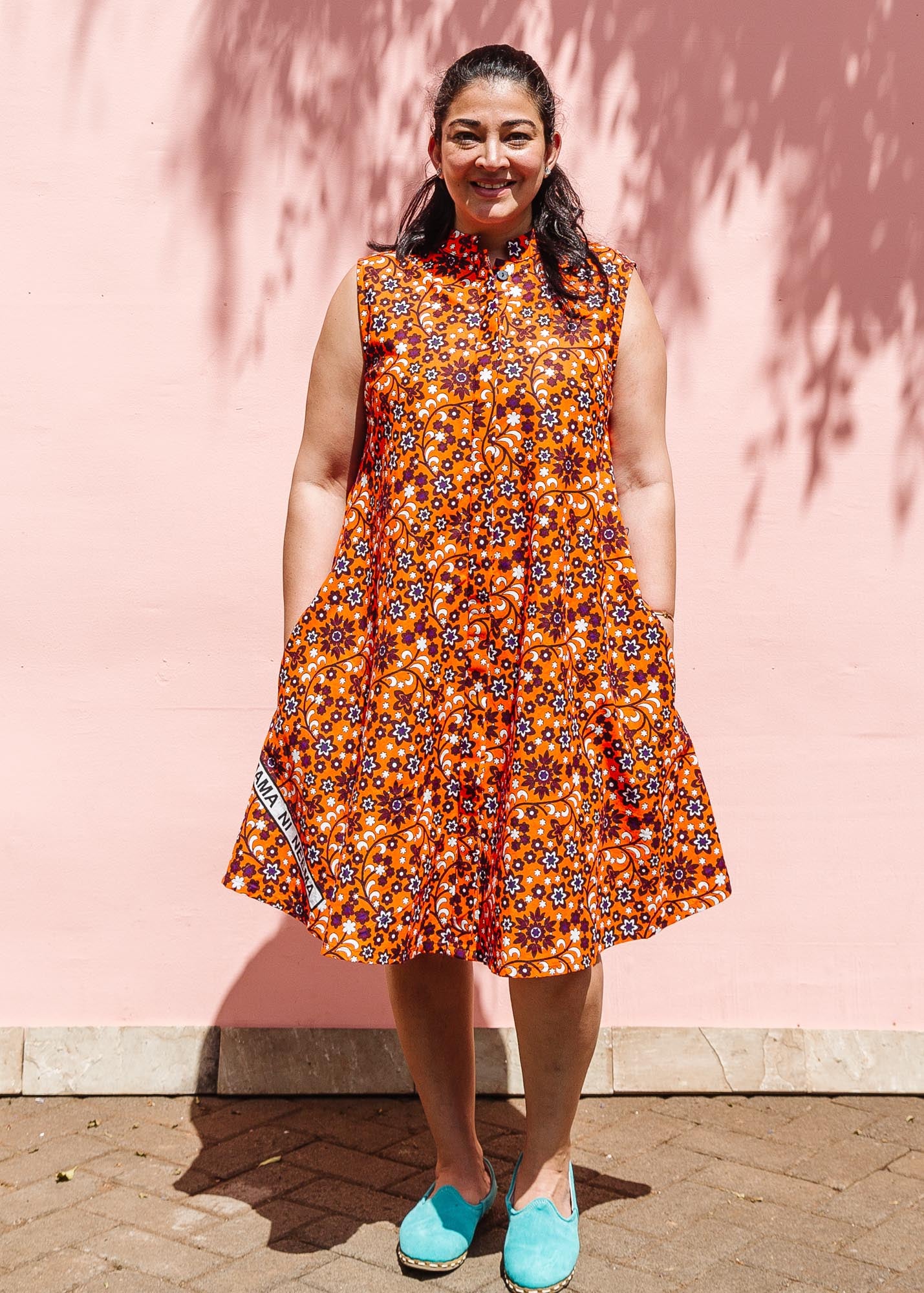 The model is wearing multi-colored floral print dress