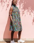  The model is wearing black, yellow, blue, red, pink print dress