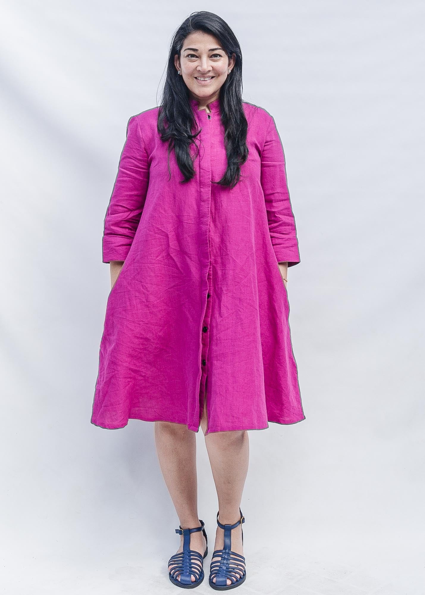 The model is wearing fuchsia dress