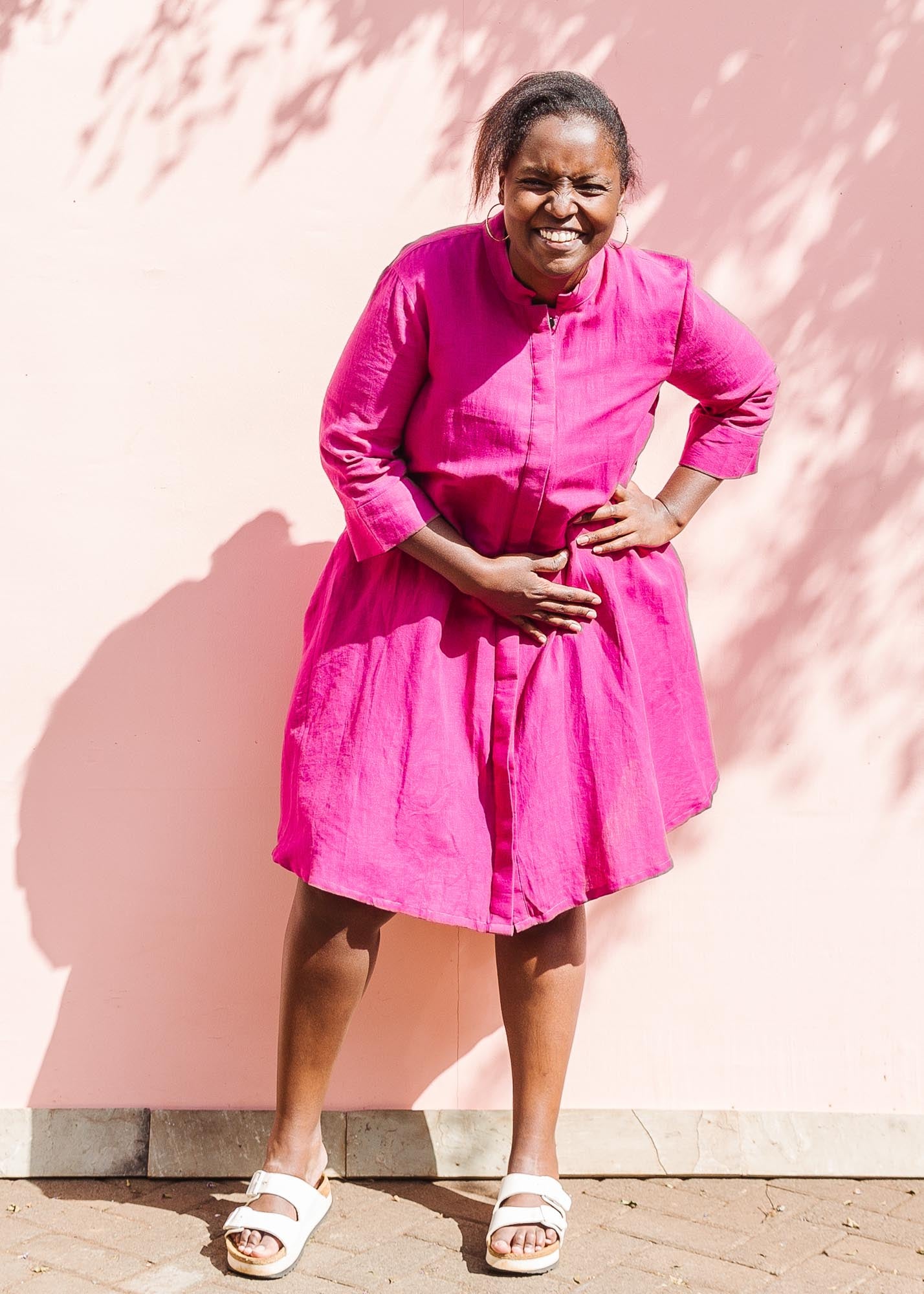 The model is wearing fuchsia dress