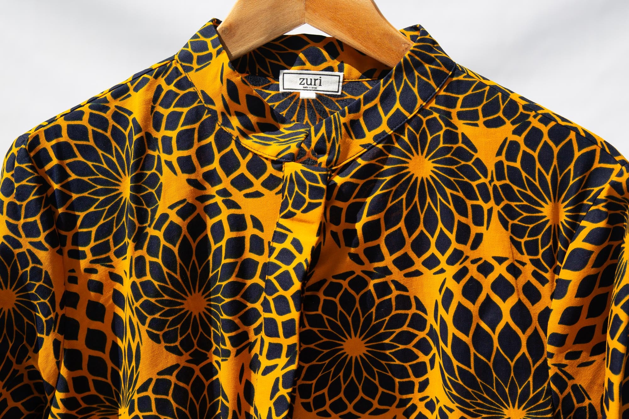 Display of black, yellow print dress