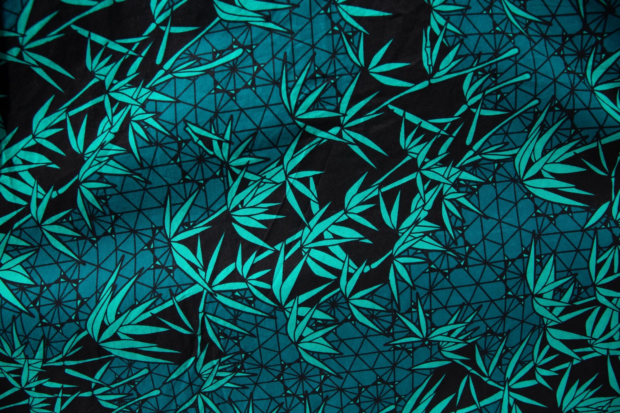 Close up display of black, blue, green print dress