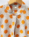 Display of white, orange, brown shirt