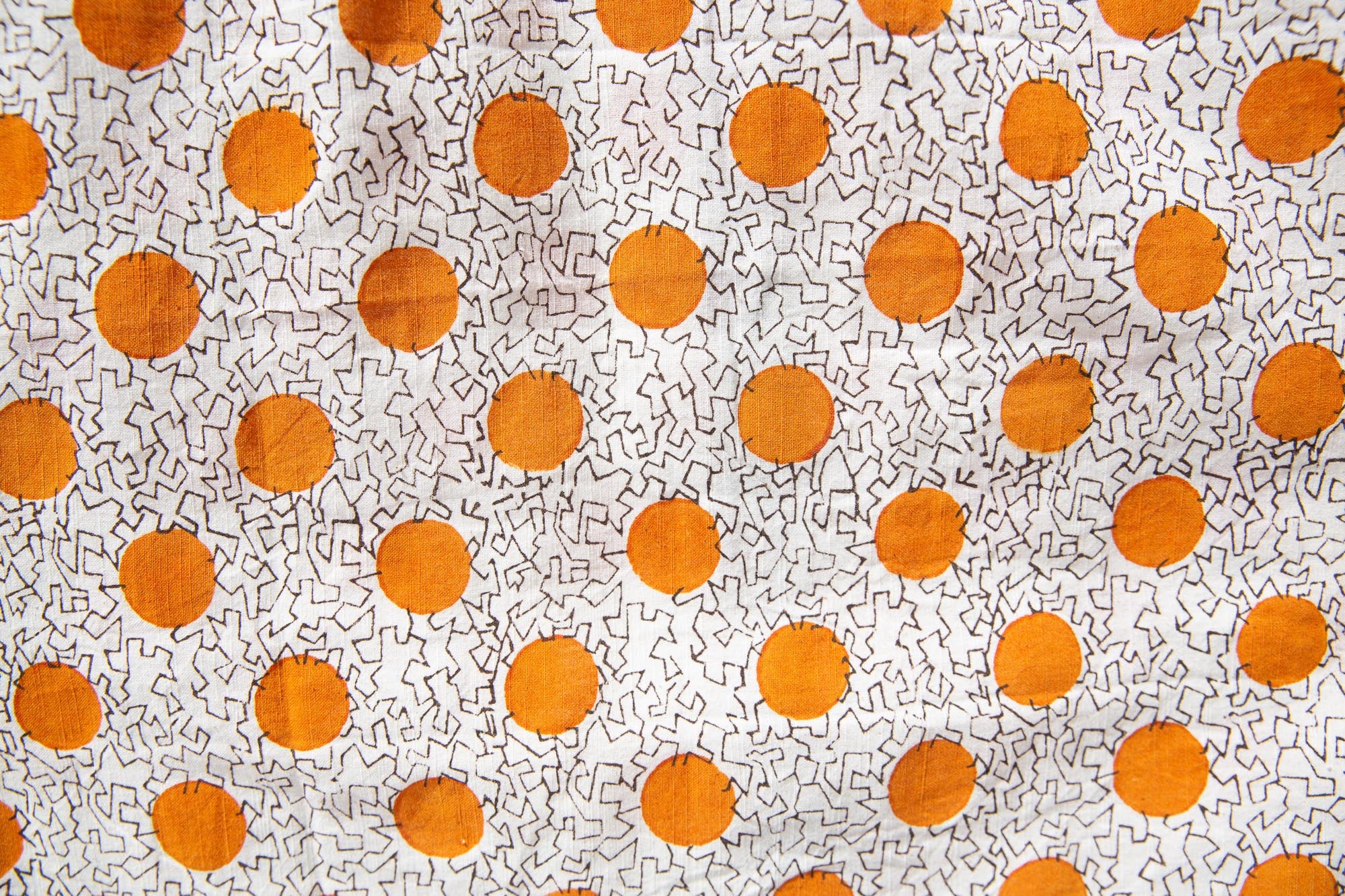 Close up display of white, orange, brown shirt