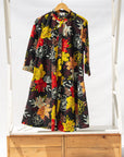 Display of black, white, red, yellow, peach floral print dress