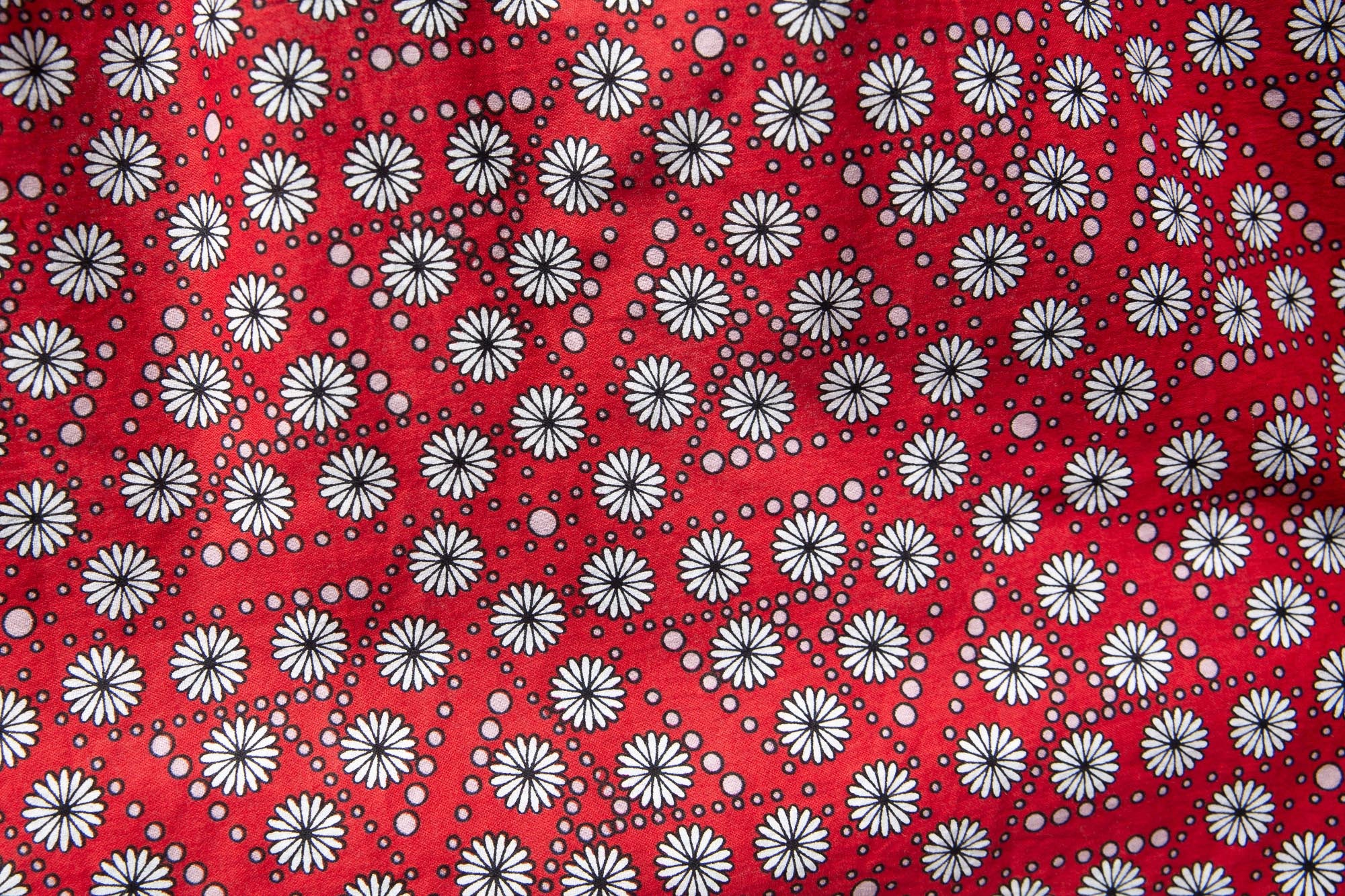 Close up display of red, black, white print shirt