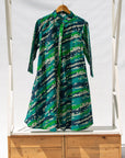 Display of black, green, white, blue and aqua print dress