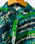 Display of black, green, white, blue and aqua print dress