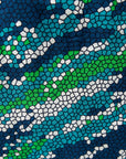 Close up display of black, green, white, blue and aqua print dress