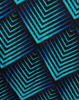 Close up display of black, blue and aqua print dress