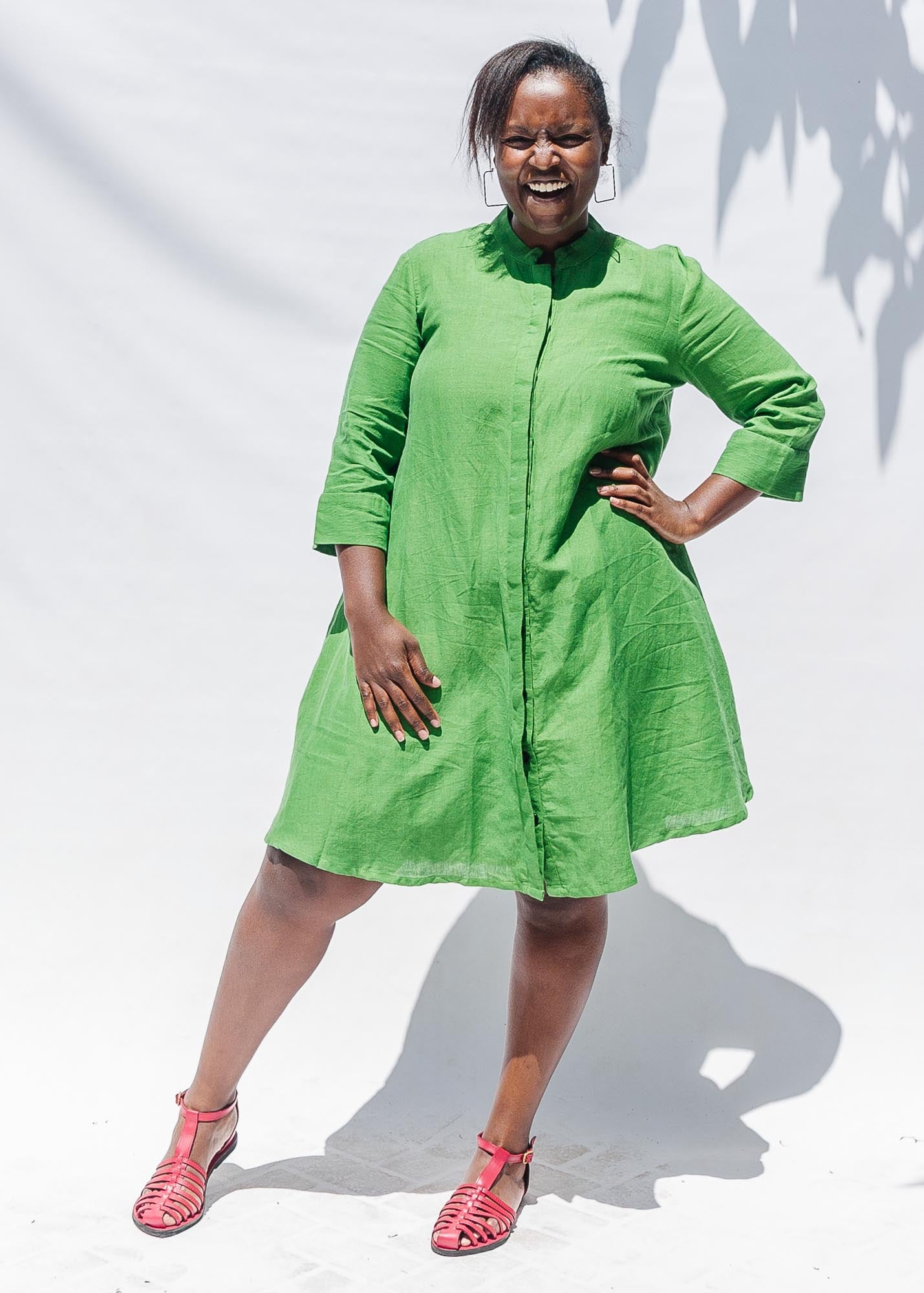 The model is wearing lichen green dress