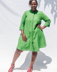 The model is wearing lichen green dress