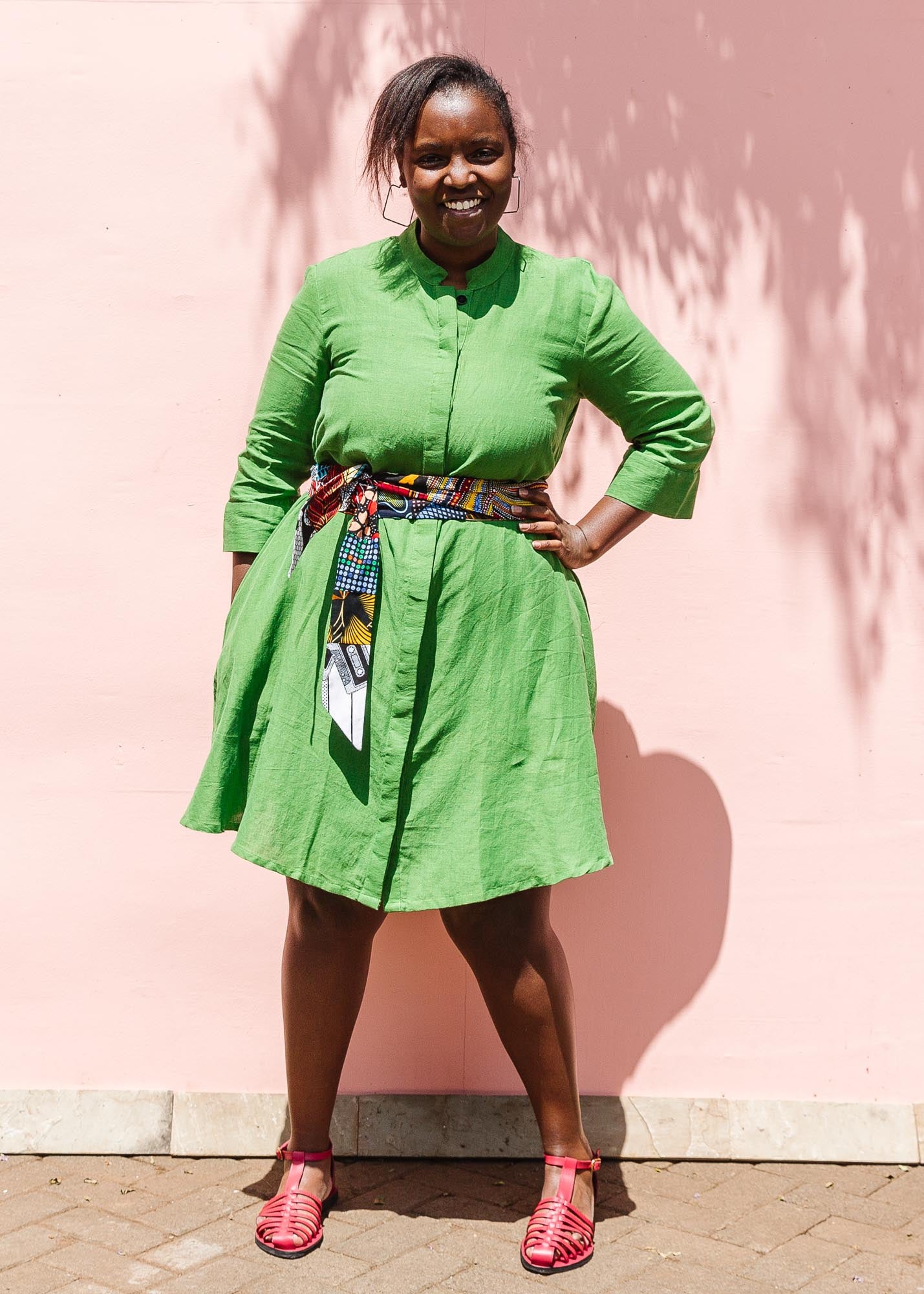 The model is wearing lichen green dress