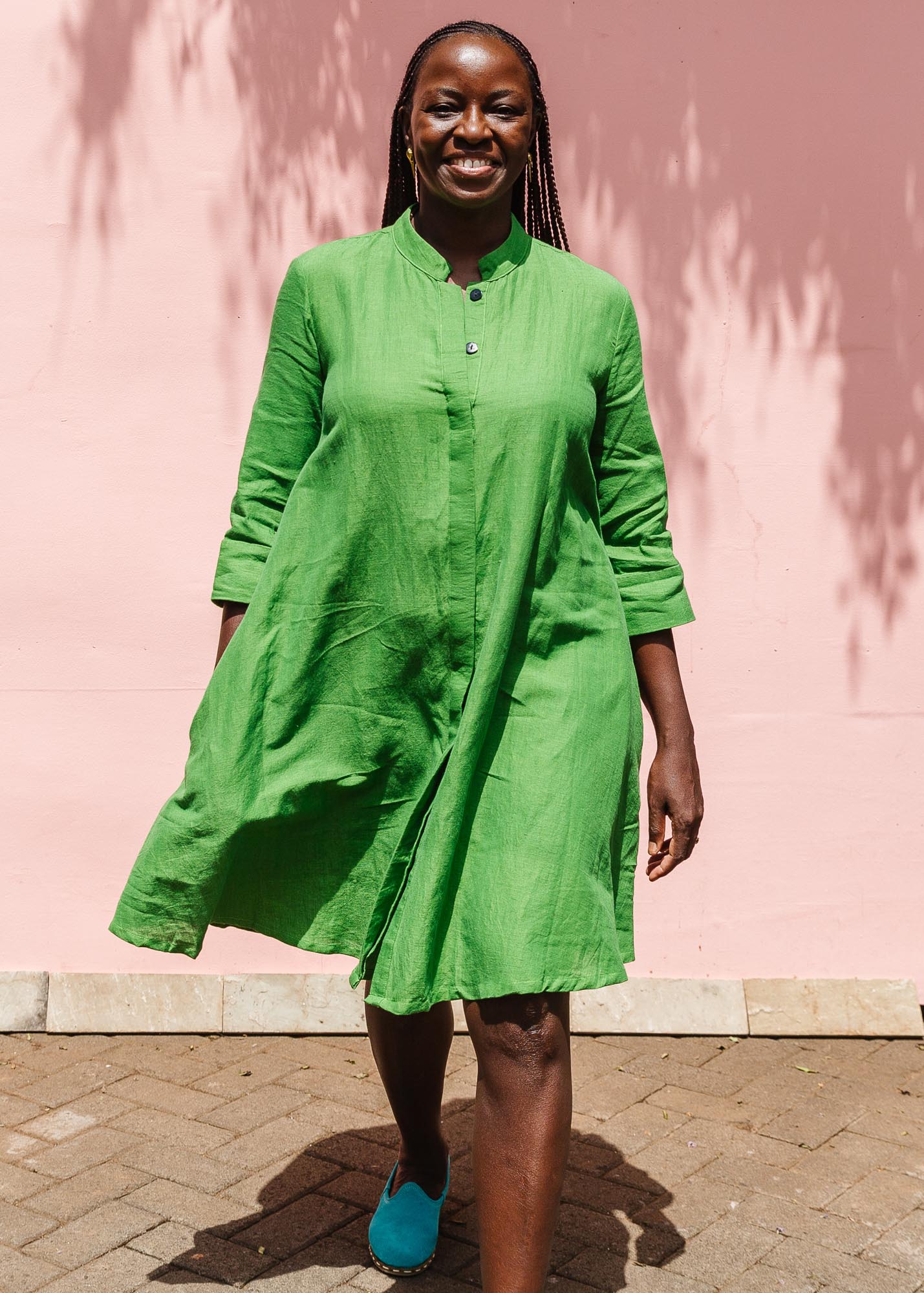 The model is wearing lichen green dress