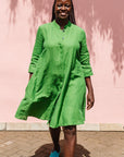 The model is wearing lichen green dress