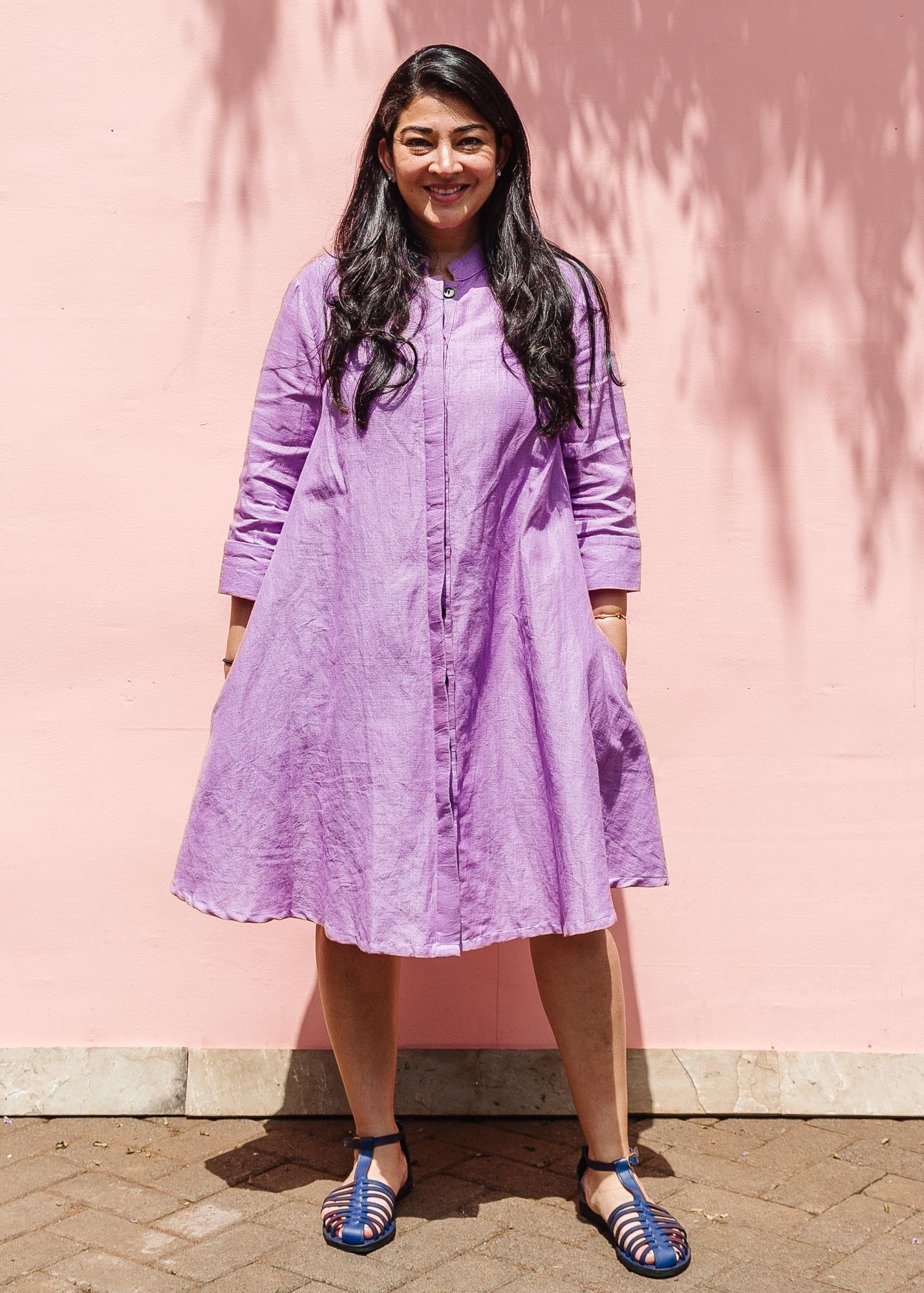 The model is wearing lavender dress