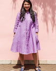 The model is wearing lavender dress