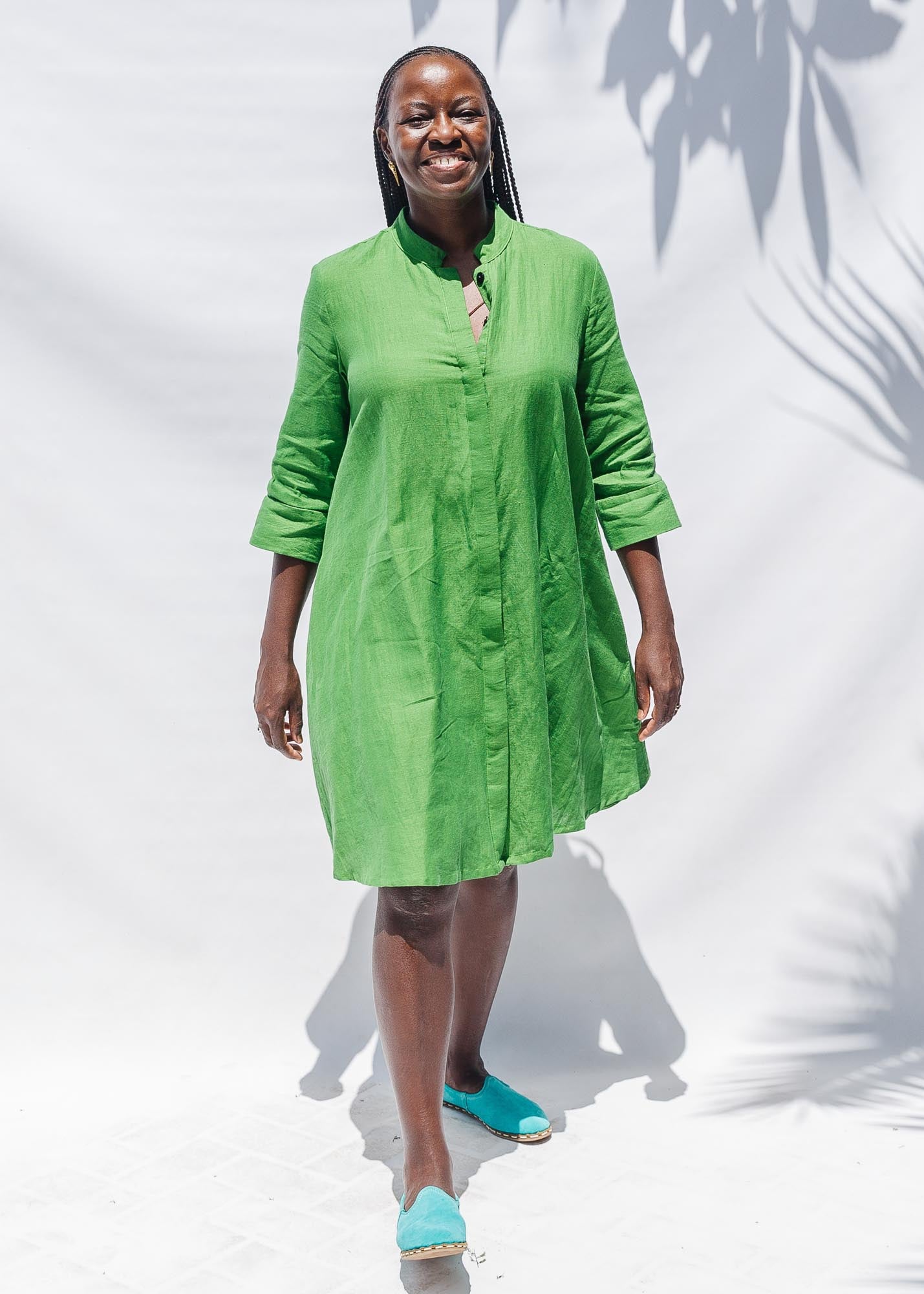 The model is wearing lichen green dress