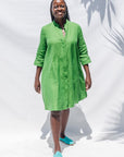 The model is wearing lichen green dress