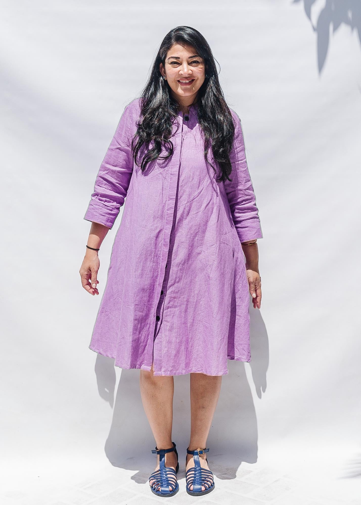 The model is wearing lavender dress