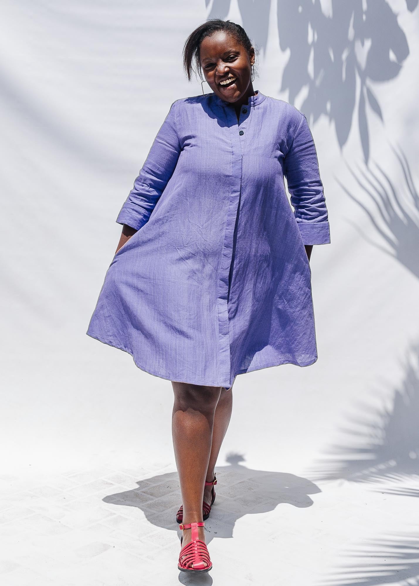 The model is wearing lavender dress