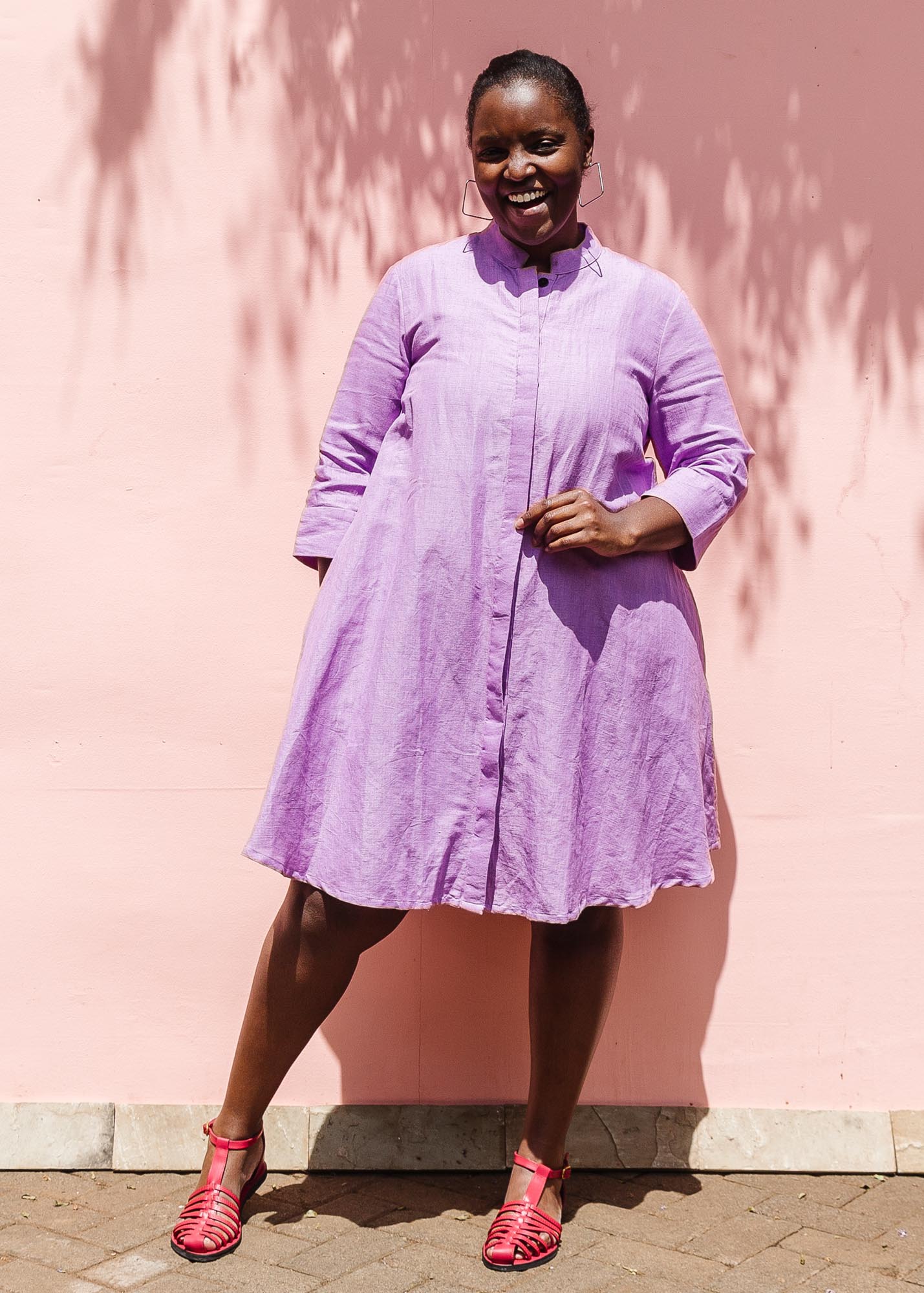 The model is wearing lavender dress