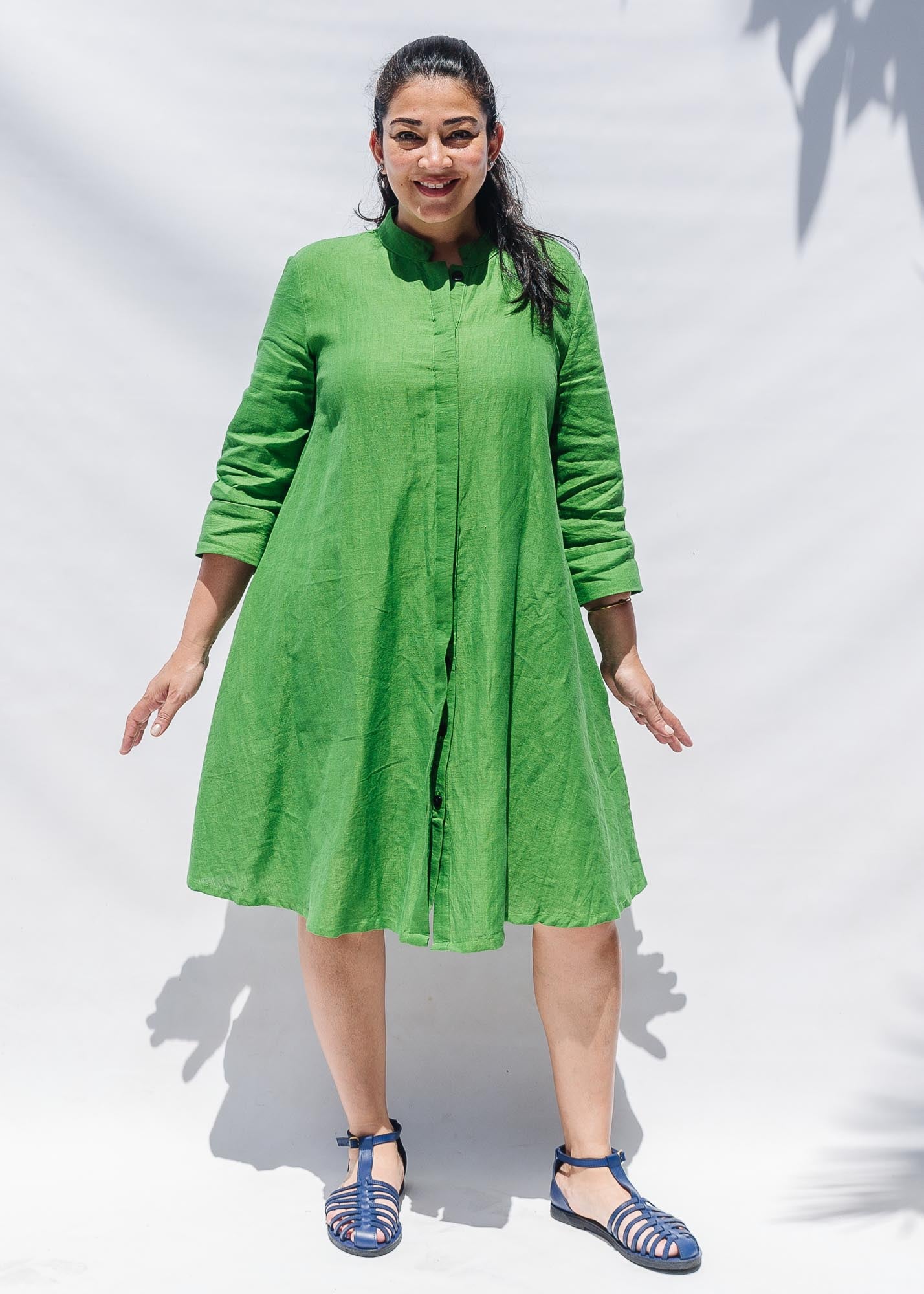 The model is wearing lichen green dress